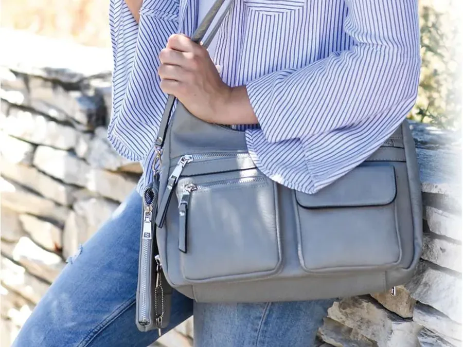 A Jessie & James concealed carry handbag worn crossbody