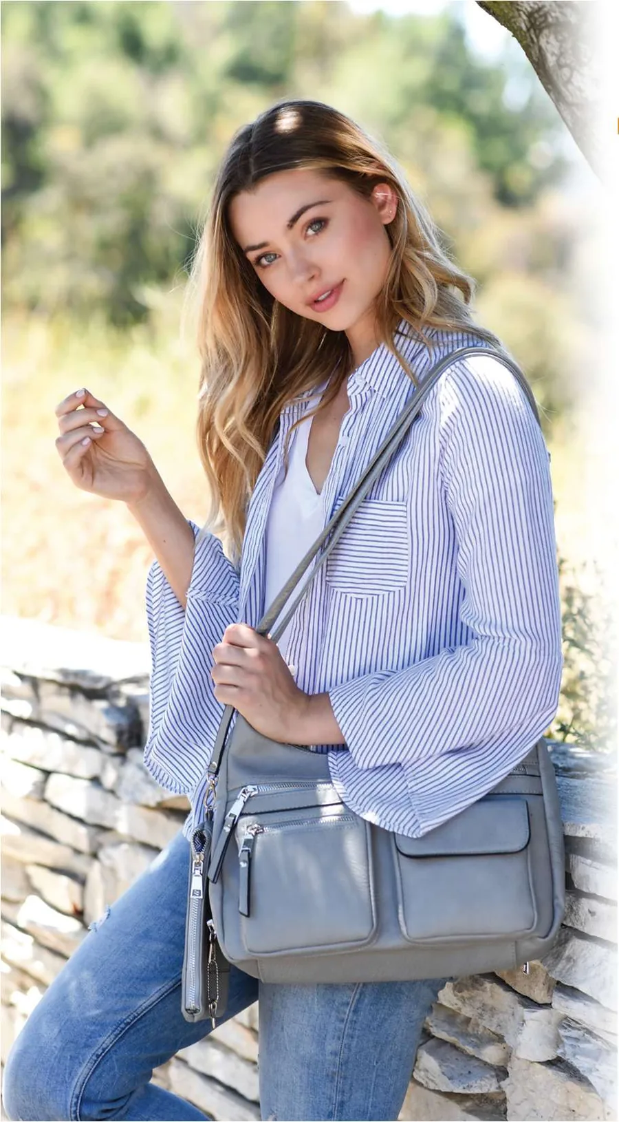 A Jessie & James concealed carry crossbody worn over the shoulder