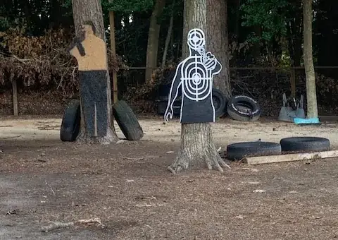 Human silhouette targets and tire barricades on the outdoor range