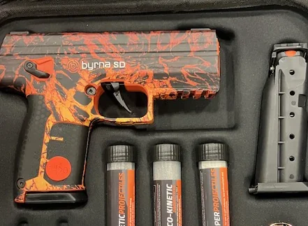 Byrna SD launcher wrapped in an orange and black marbled skin